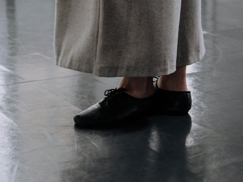 Close-up shot of a person's feet in a balanced stance.